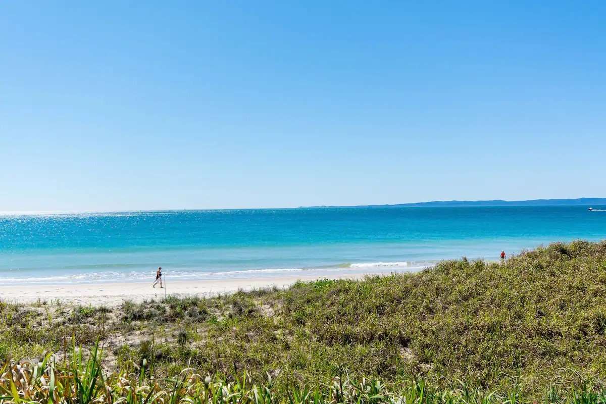 White sand and turquoise ocean beyond the dunes at Woorim Beach